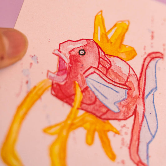 Carte postale Magicarpe (Edition Moche) -Carte postale imprimée d’une illustration réalisée à l'aquarelle et aux crayons de couleurs.Le dessin vient d'un challenge en live sur Twitch dans lequel j'ai dessiné les 151 Pokémon de la première génération de 1995 en 24h en live sur Twitch, MAIS : en moche ! Voir la vidéo : https://youtu.be/0MyLD5bqc1Q Papier 300g recyclé. Possibilité de la faire signer et dédicacer à la main en choisissant l'option de livraison "Dédicacée".-Brunograffer Boutique Art de Brunograffer - Carte postale imprimée d’une illustration réalisée à l'aquarelle et aux crayons de couleurs.Le dessin vient d'un challenge en live sur Twitch dans lequel j'ai dessiné les 151 Pokémon de la première génération de 1995 en 24h en live sur Twitch, MAIS : en moche !
 
Voir la vidéo : https://youtu.be/0MyLD5bqc1Q
 
Papier 300g recyclé.
Possibilité de la faire signer et dédicacer à la main en choisissant l'option de livraison "Dédicacée".